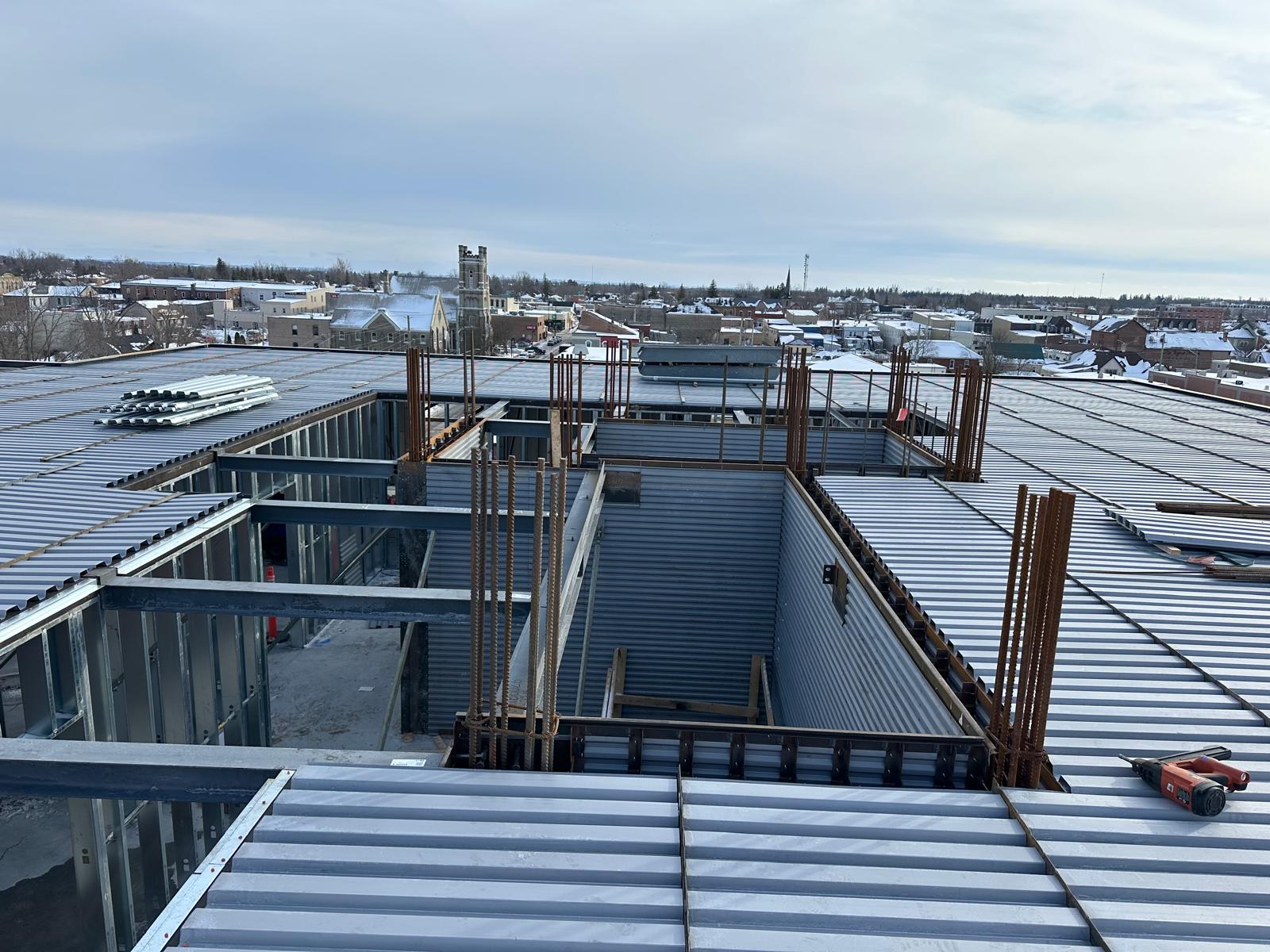 Rooftop view of steel framing, beams and decking mid-build