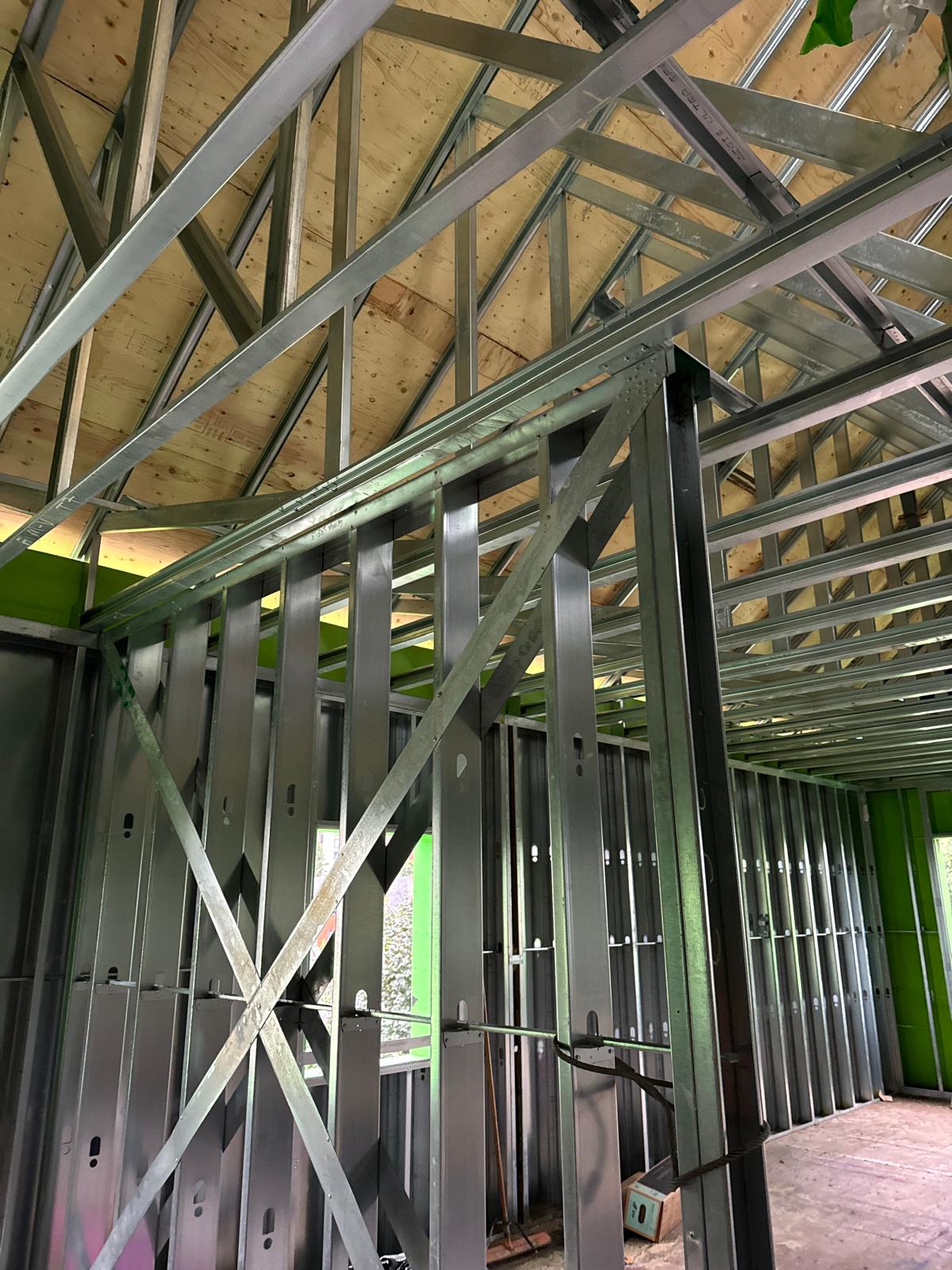 Interior steel stud walls and bracing under an exposed wood roof deck
