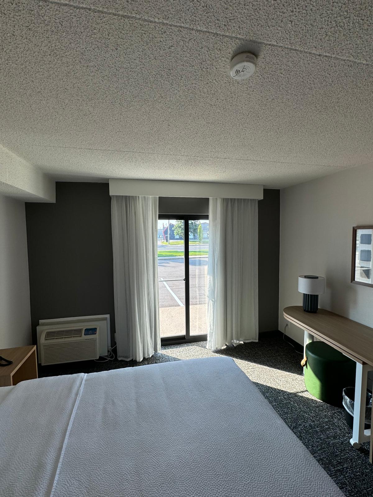 Completed guest room with acoustic ceiling, painted feature wall and finished flooring