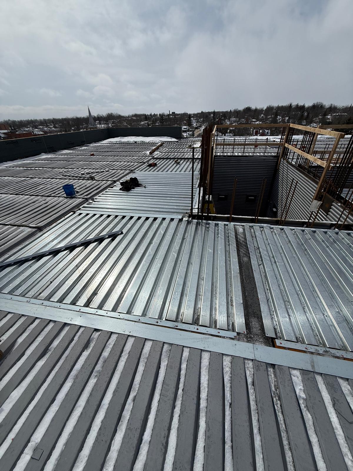 Corrugated steel roof decking laid across a commercial roof